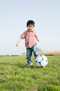 Young boy playing football